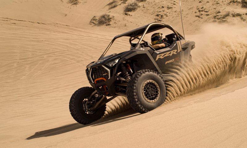 2025 Polaris ORV RZR Pro R Ultimate kicking up sand racing through the desert.