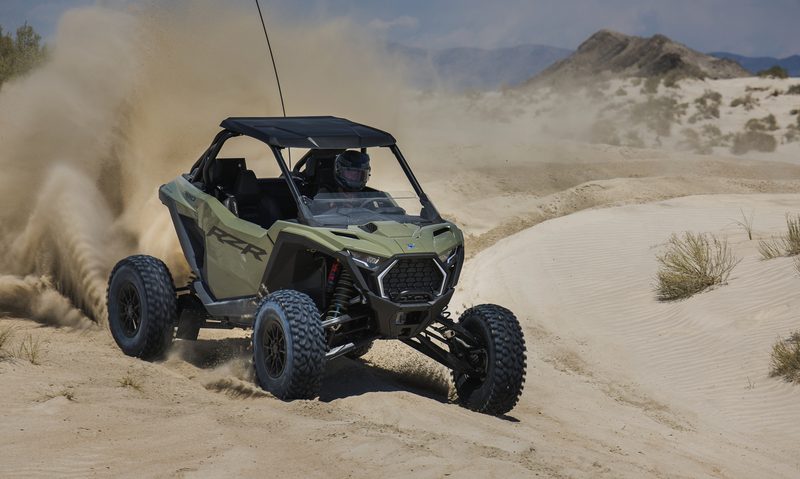 2025 Polaris ORV RZR Pro S Ultimate racing along a desert dune corner.