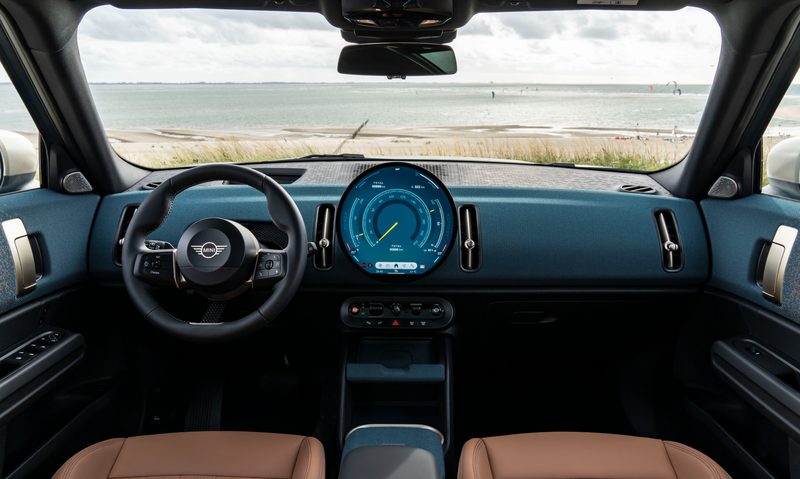 2025 all-electric MINI Countryman ALL4 SE parked facing the beach interior shot of front seats and dashboard.