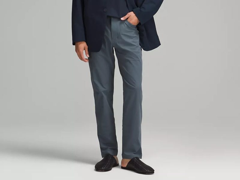 A man with his pants in one of the many pockets of the Lululemon ABC Classic-Fit 5 Pocket Pant Warpstreme men's pants.