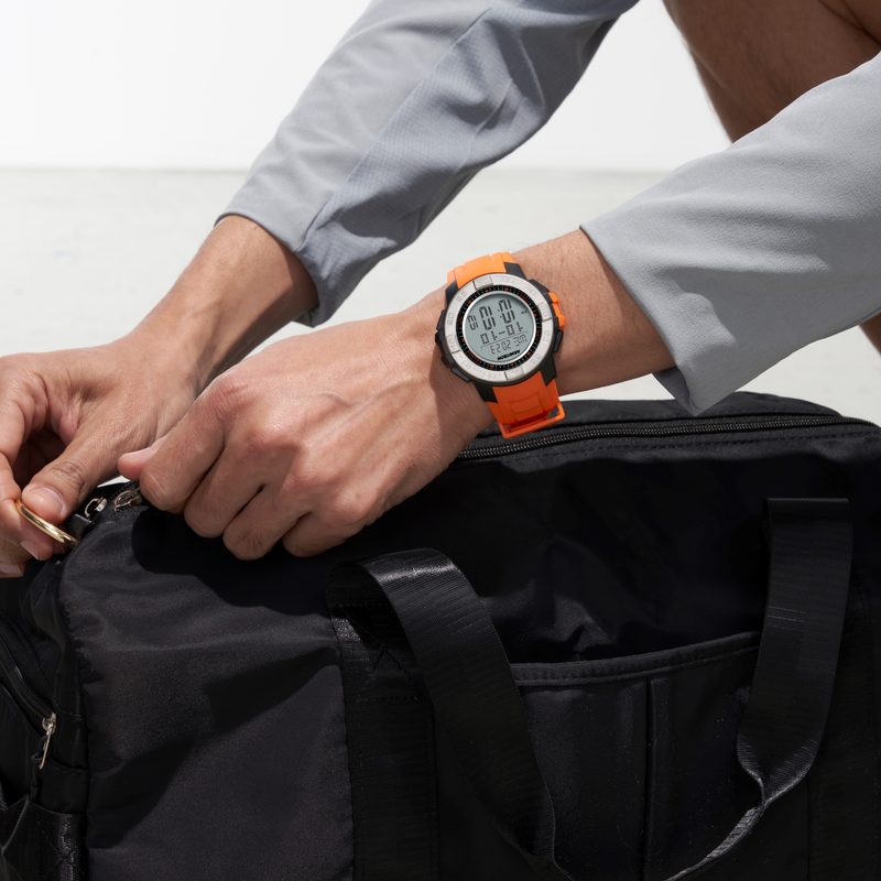 Armitron smartwatch on a wrist closing a bag