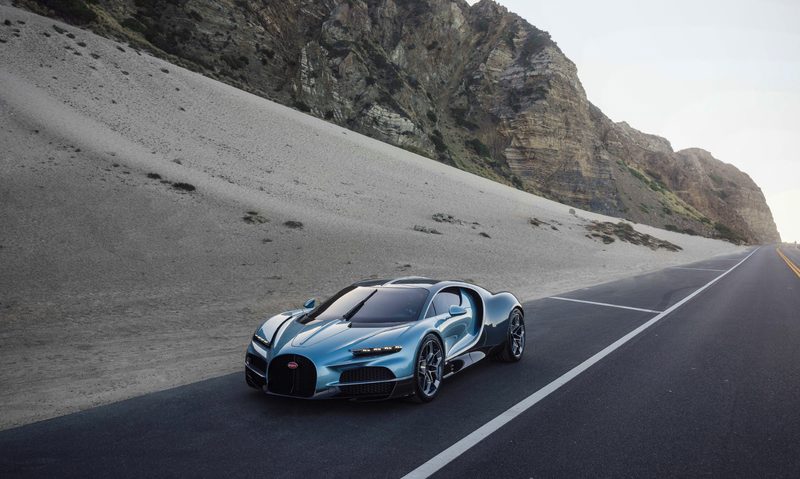 BUGATTI Tourbillon during US Roadshow parked on the side of the road between low hills and the beach.