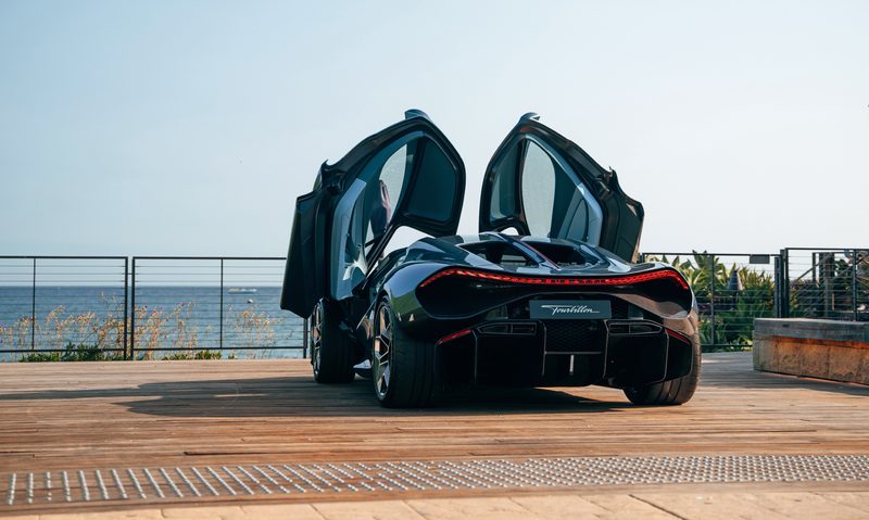 BUGATTI Tourbillon during US Roadshow with gullwing doors raised parked facing the ocean.