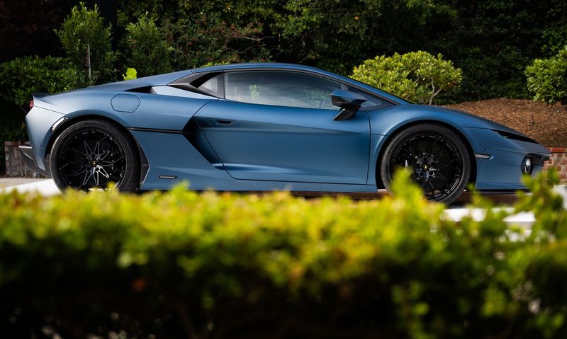 Blue Lamborghini Temerario right side view at Pebble Beach during Monterey Car Week.