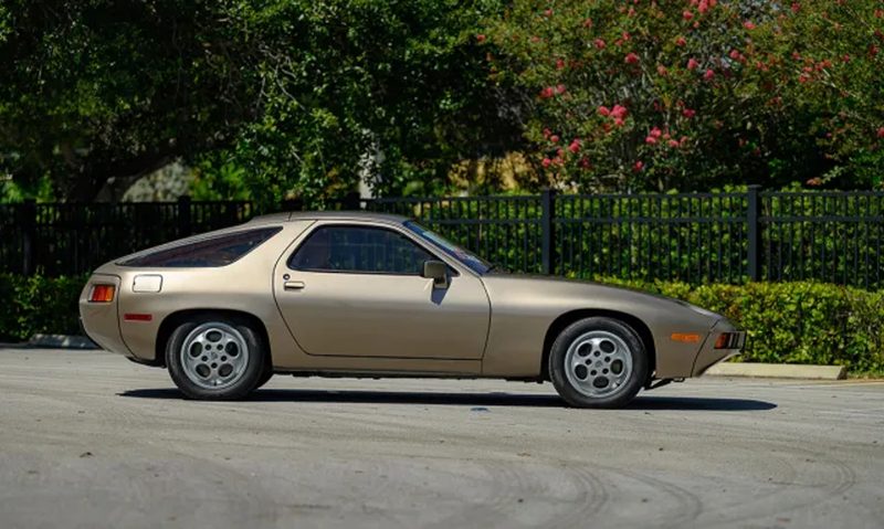 Bonhams is auctioning this gold 1979 Porsche 928 that Tom Cruise drove in the film Risky right profile.