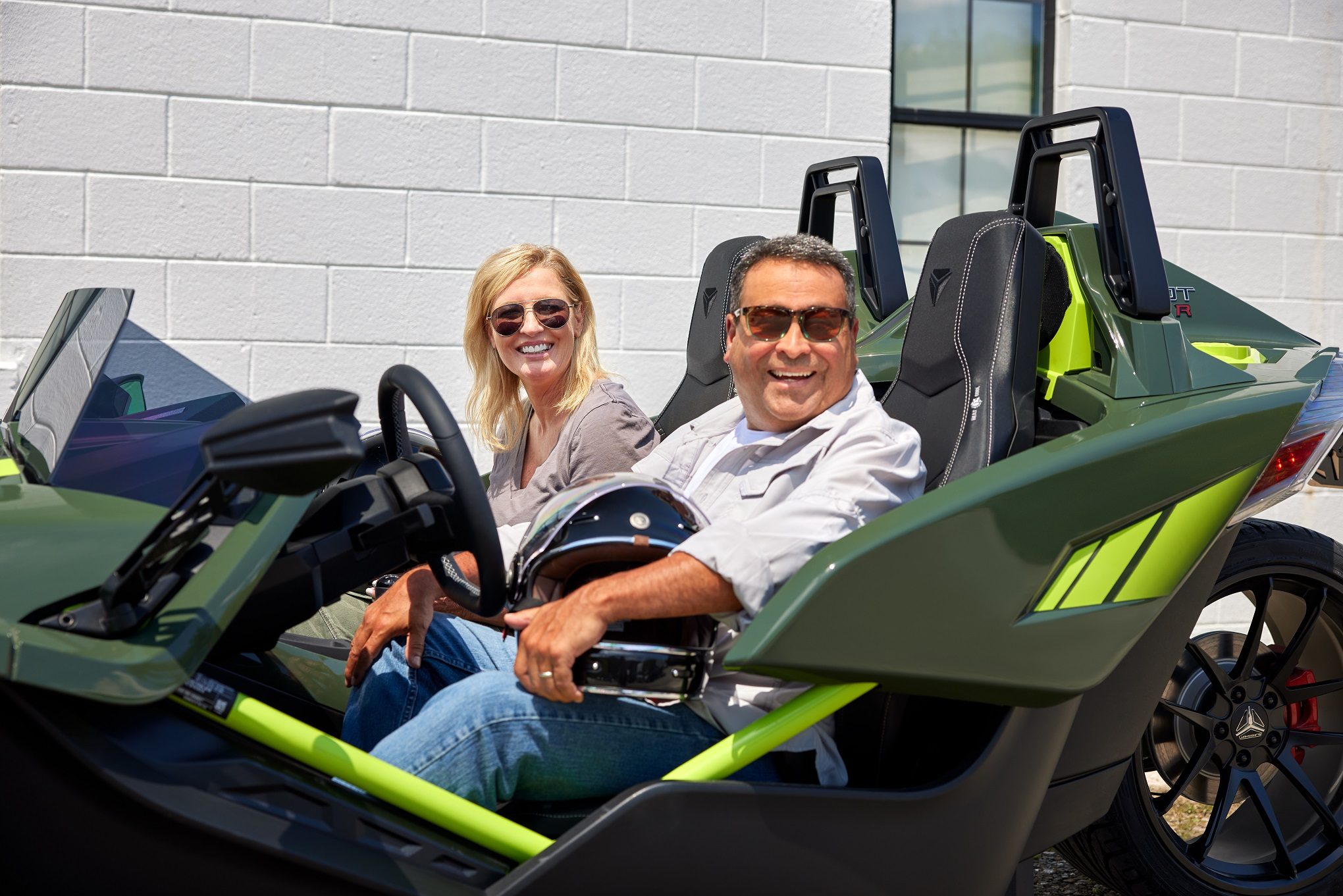 Couple behind the wheel of 2024-Slingshot-R-Accessorized