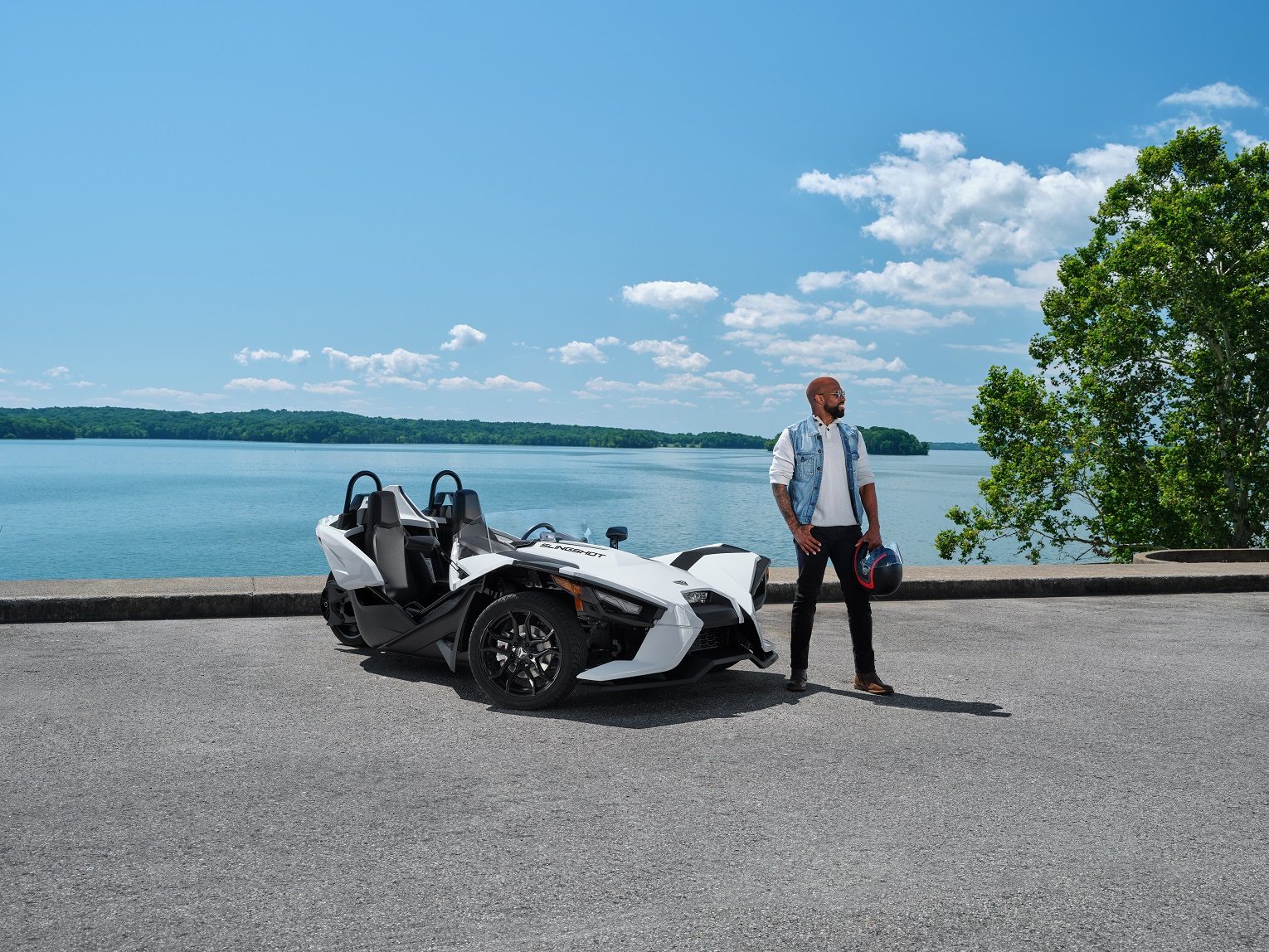 Man standing next to Polaris Slingshot S in white