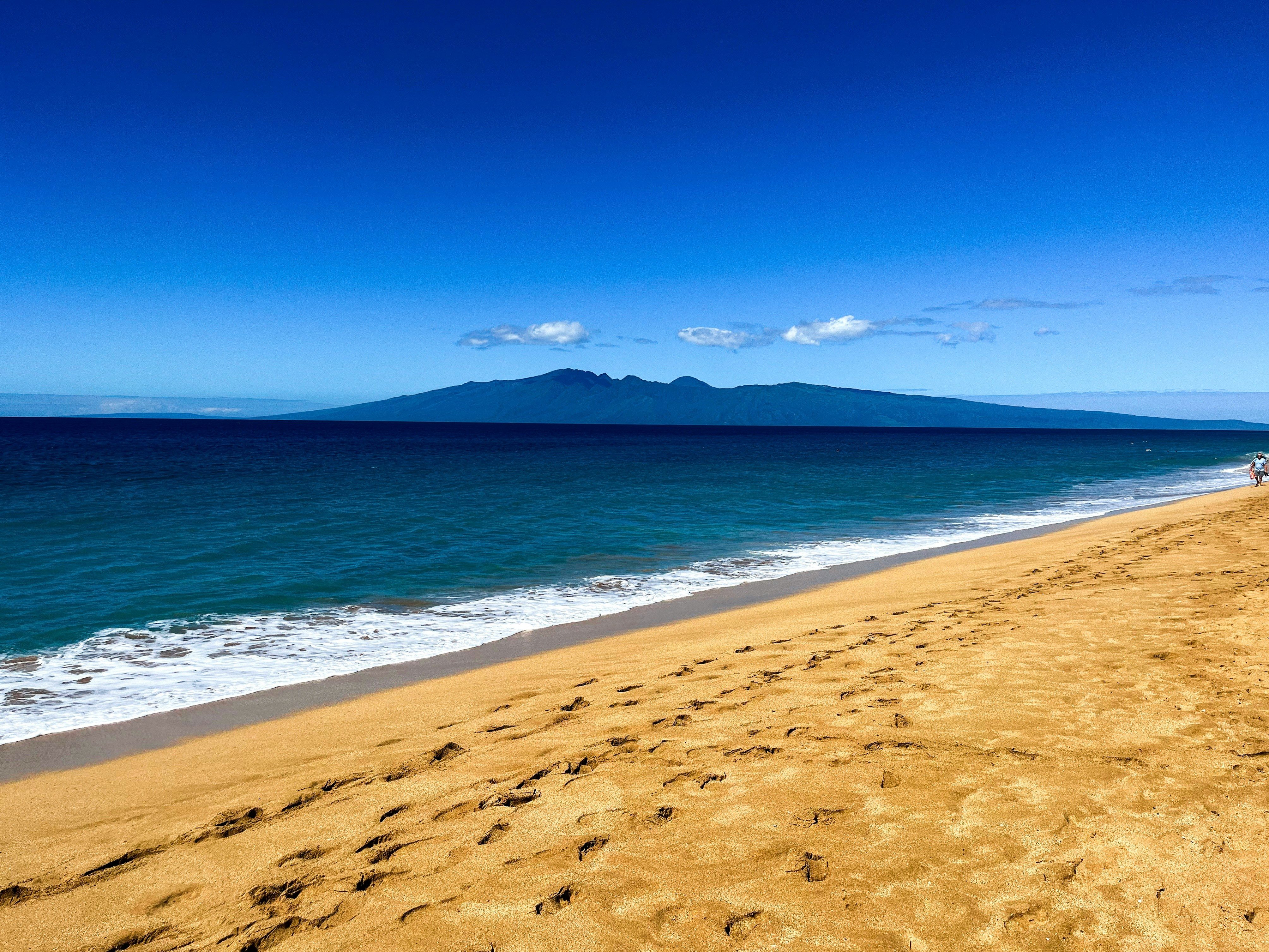 Sand ocean and mountains around Maui