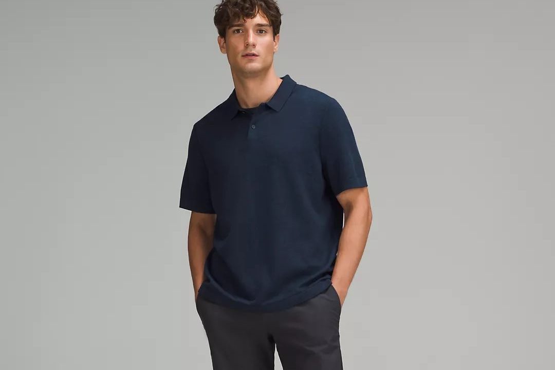 A man posing with Lululemon's New Venture Short-Sleeve Knit Polo Shirt.