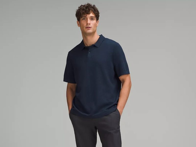 A man posing with Lululemon's New Venture Short-Sleeve Knit Polo Shirt.