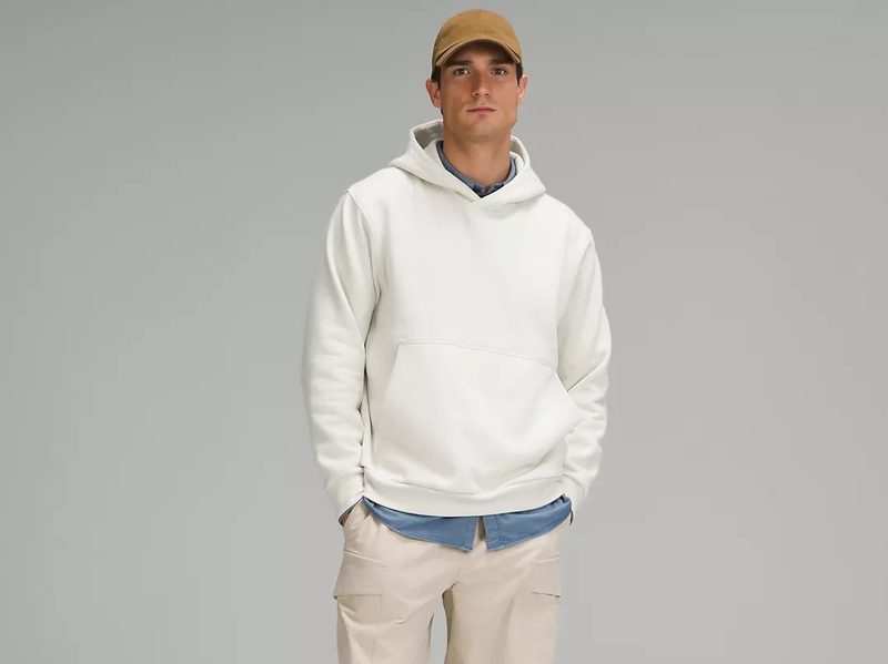 A man wears the Steady State Pullover Hoodie from Lululemon.