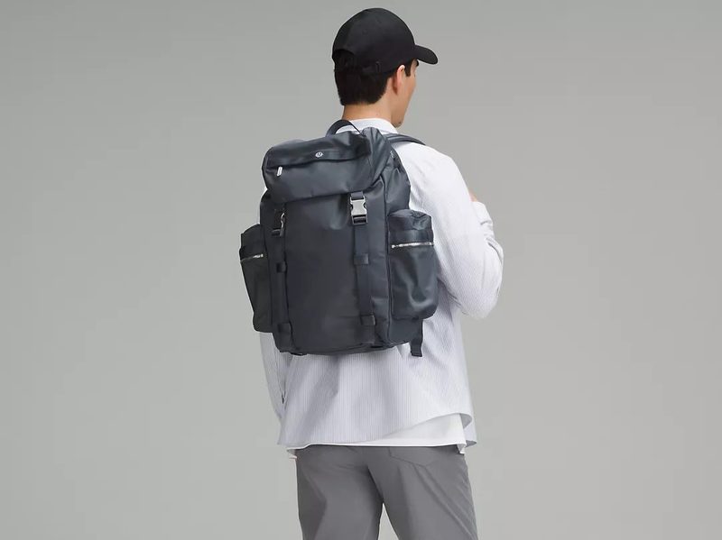 A man sporting the Wanderlust Backpack 25L from Lululemon.