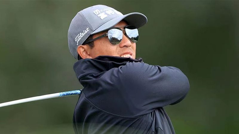 C.T. Pan golfing in Uswing sunglasses.