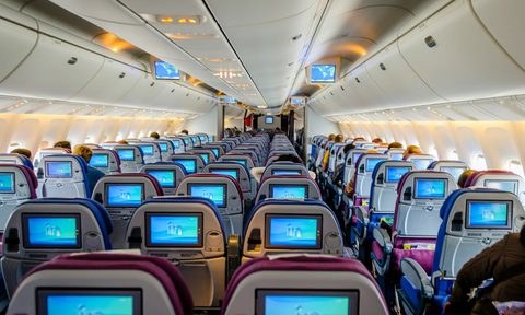 Inside of a plane with screens on