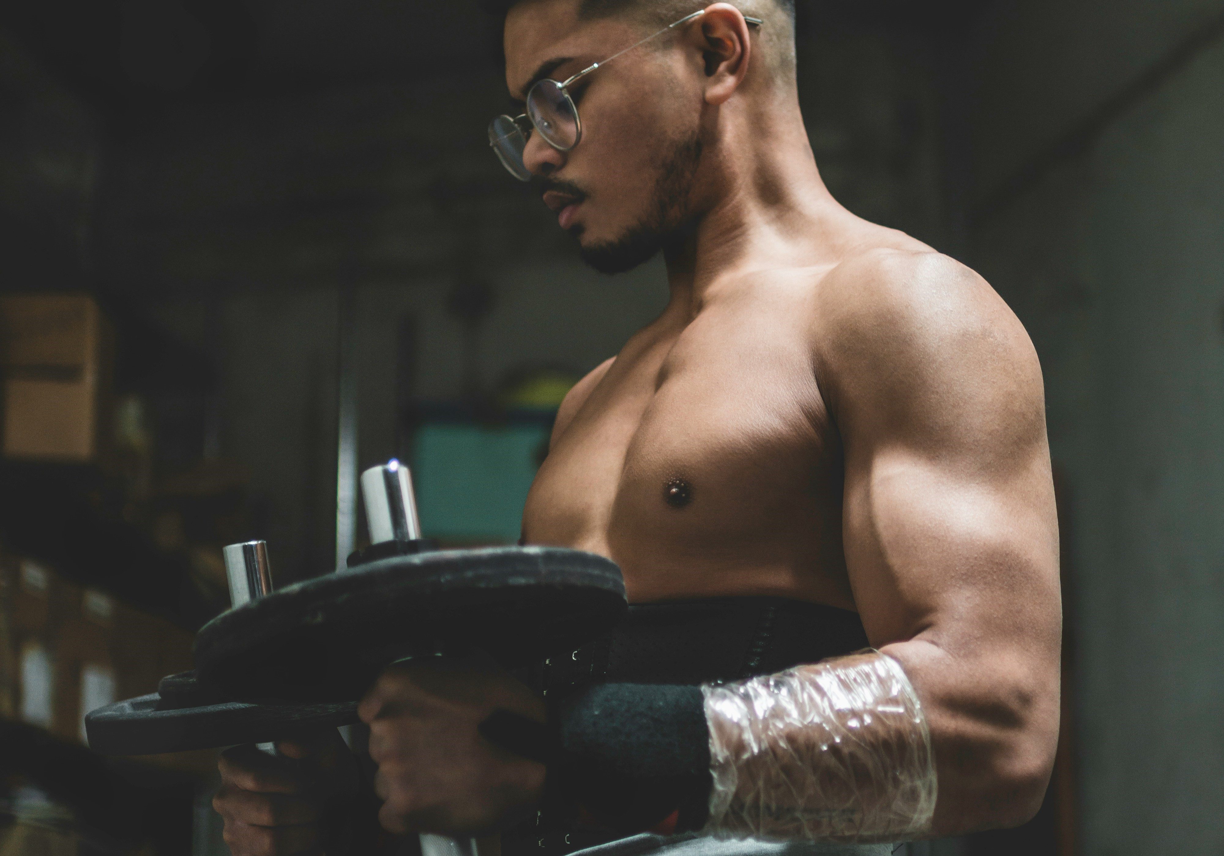 Man doing hammer curls. glasses