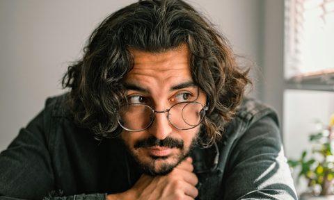 Man with long hair and glasses