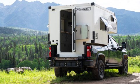 Outpost Campers' Outpost 6.5 truck camper parked with mountains in the background.