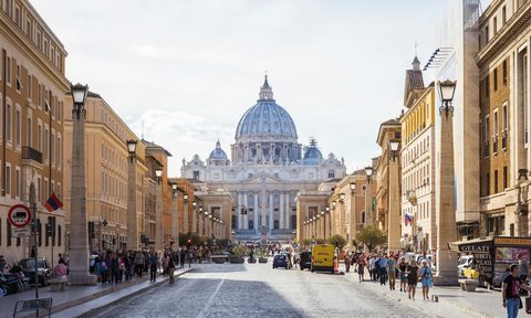 people walking beside white and brown dome building during daytime