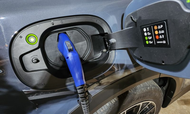 2025 Mazda CX-70 PHEV charging port with Level I adapter cable plugged in and charging.