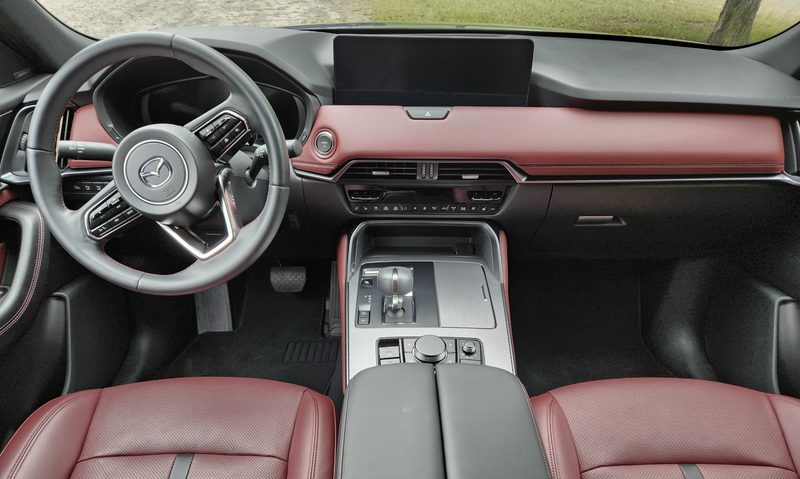 2025 Mazda CX-70 PHEV interior view front seats, console, and dashboard including display screen.