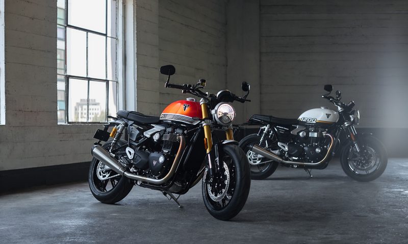 2025 Triumph Speed Twin 1200 and Speed Twin 1200 RS inside a building with a concrete floor.