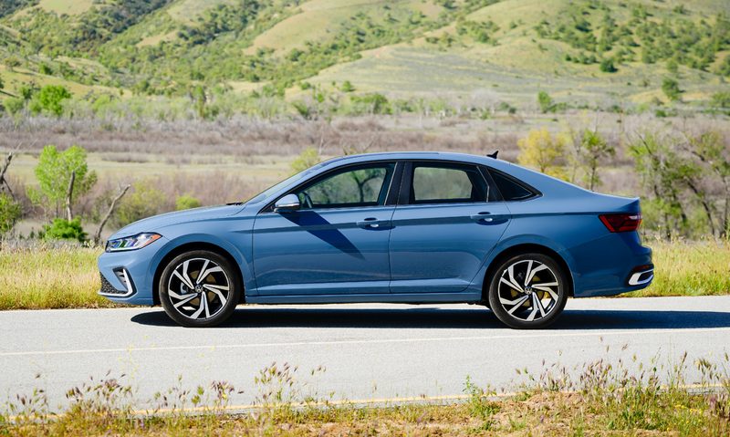 2025 VW Jetta parked on the side of a road with rocky hillside in background.