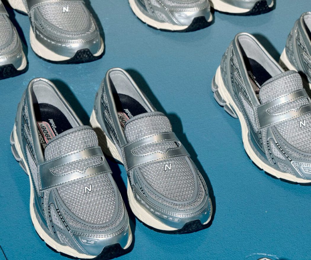 silver New Balance loafer shoes on blue background