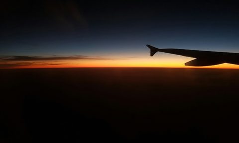 Sunset over airplane wing