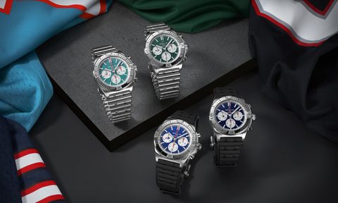 Four Breitling Chronomat B0142 Teams Editions watches on black table