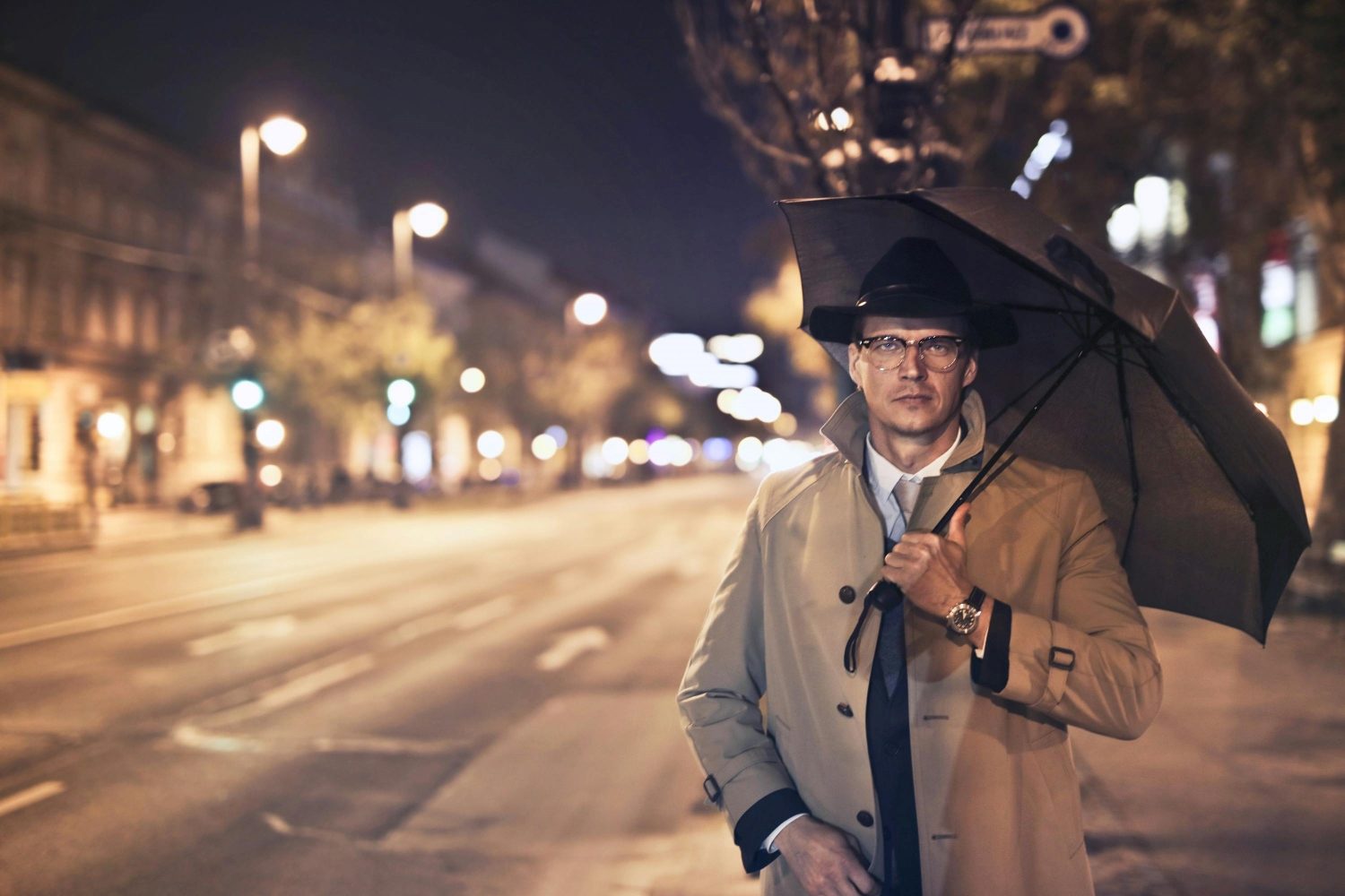 Man in trench coat with umbrella