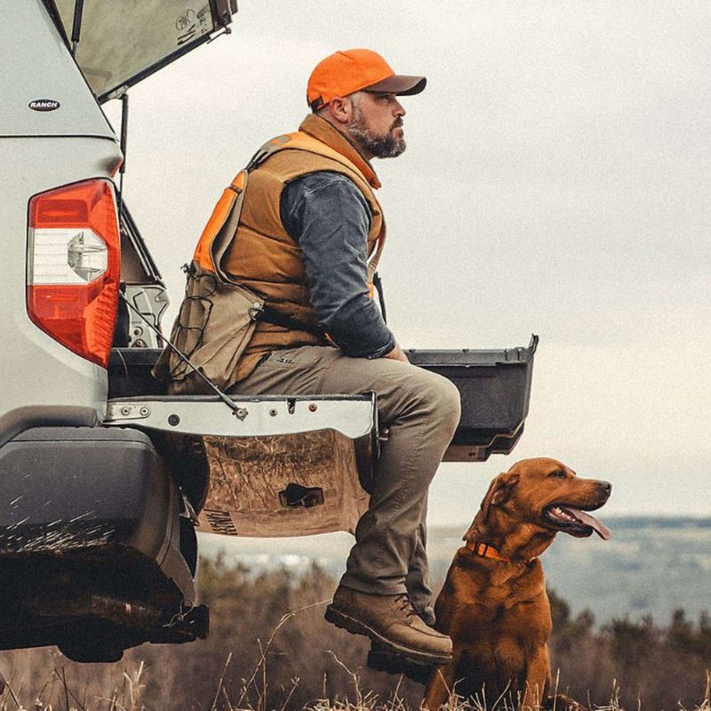 Man on tailgate with his dog