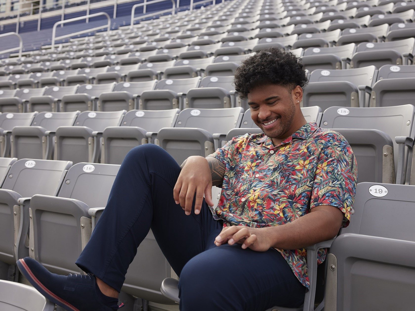 Tua Tagovailoa wearing a piece from his Perry Ellis clothing collection in the stands