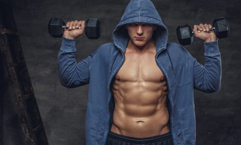 Man lifting weights to build muscle.