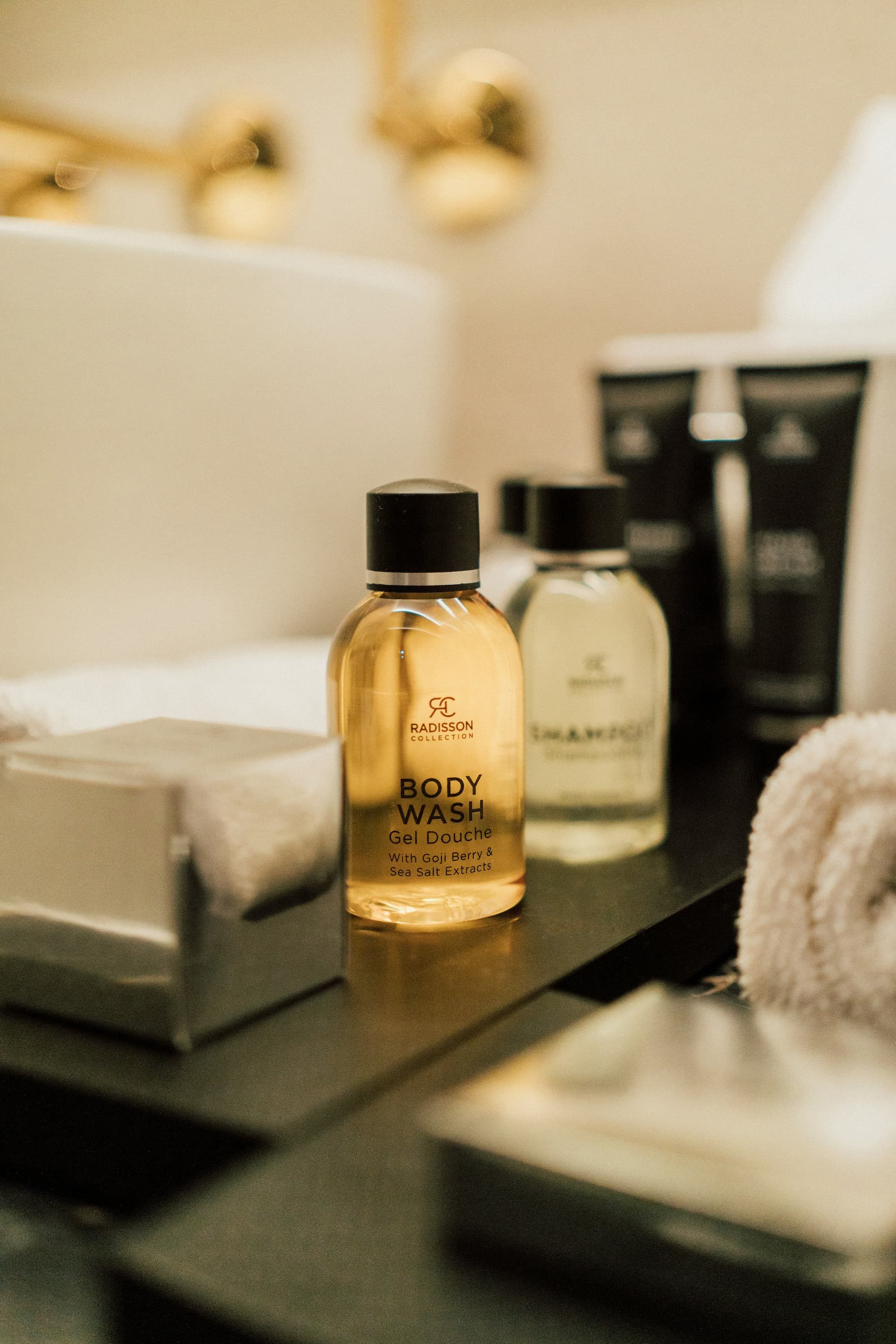 close up of travel sized body wash on counter