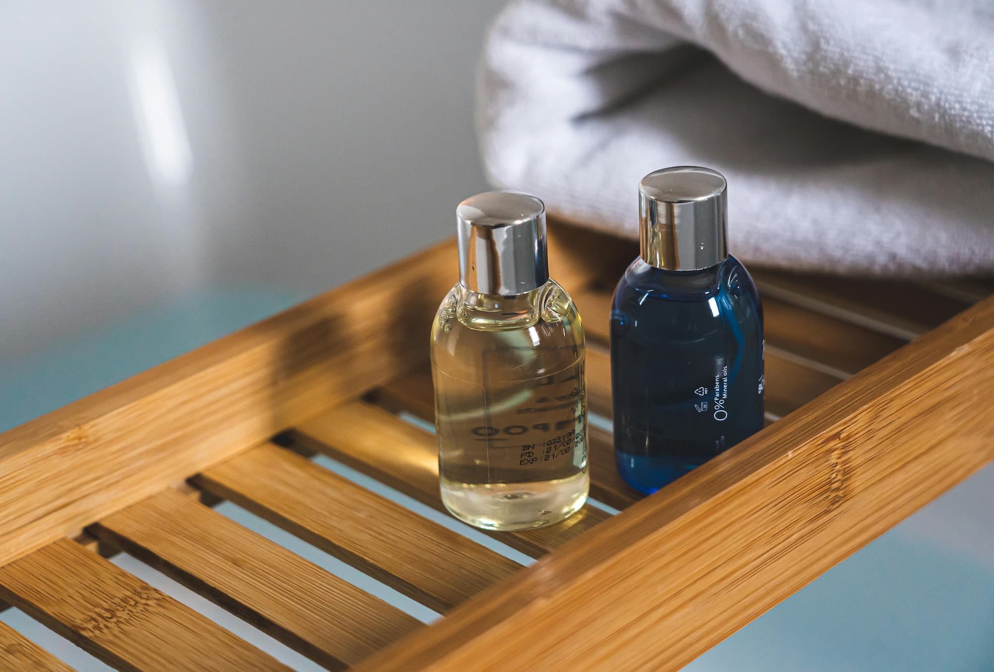 travel sized bottles on a wooden tray