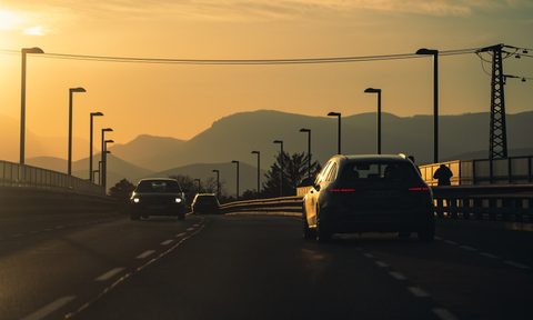 Car driving toward mountains