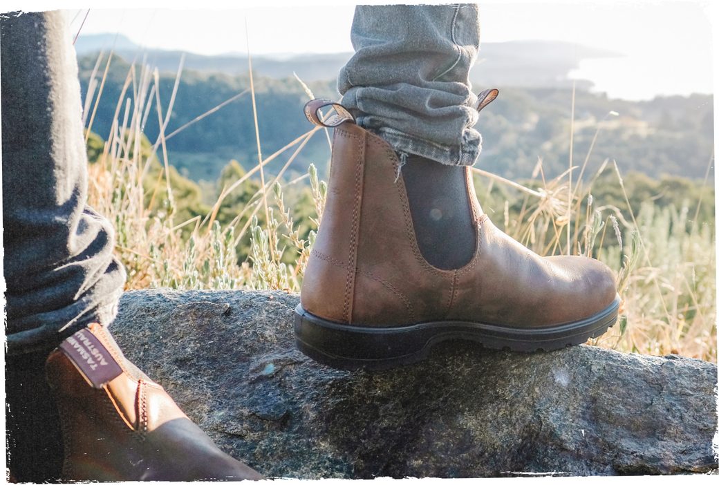 man stepping on ledge in Blundstone boots