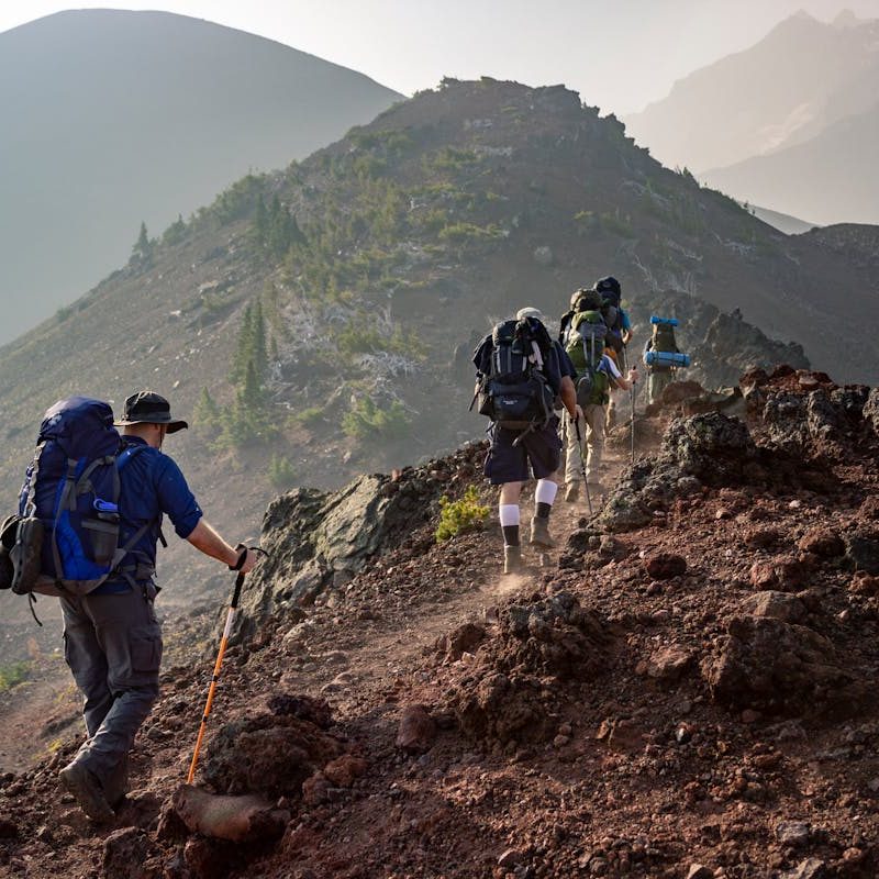 Man backpacking with family