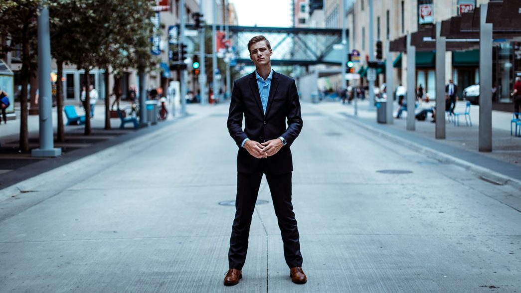 man standing in road wearing suit