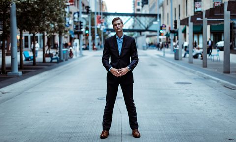 Man standing in road wearing suit