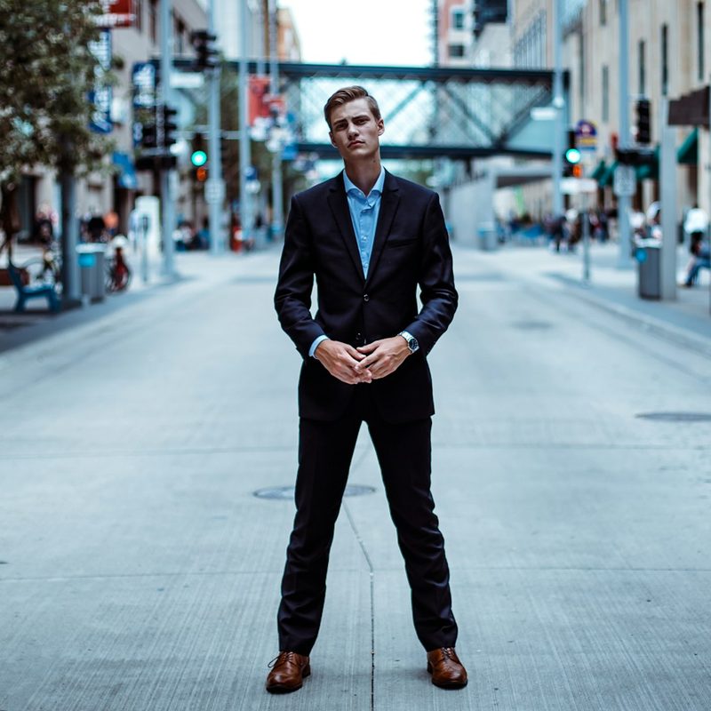 Man standing in road wearing suit