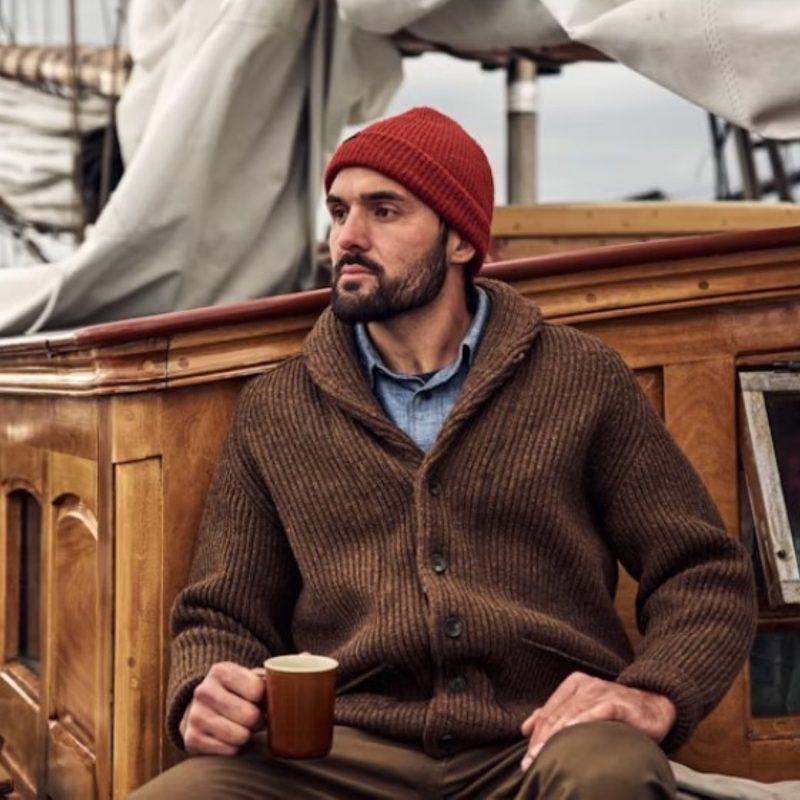 Man drinking coffee in a cardigan