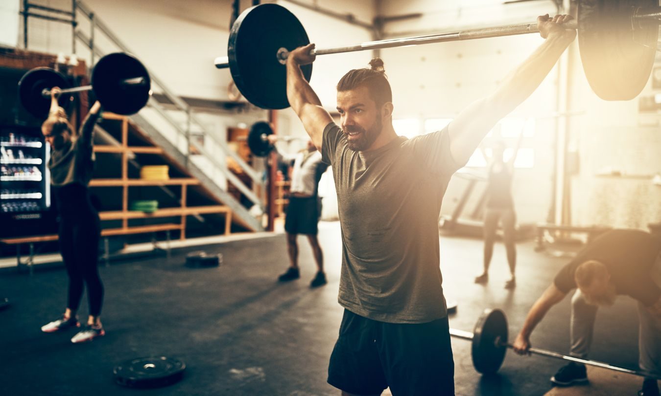 man lifting a weight above his head