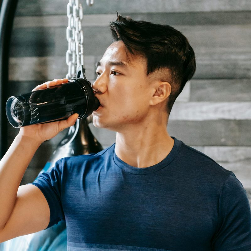 Man drinking supplement.
