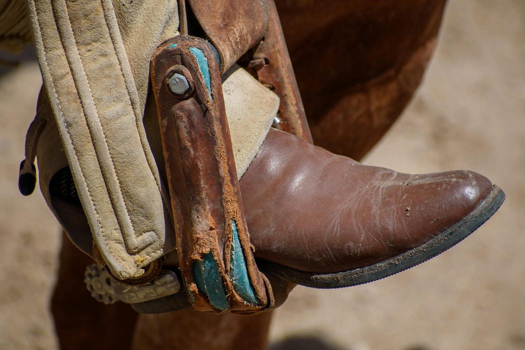 close up of cowboy boot in stirrup