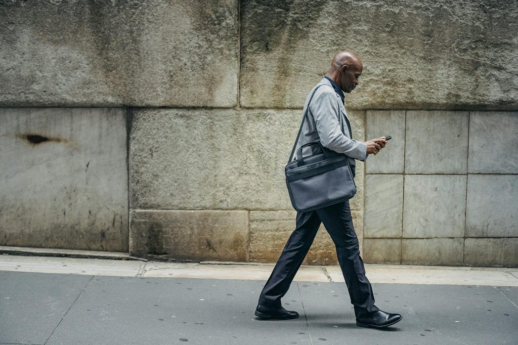 man wealking wearing suit and boots