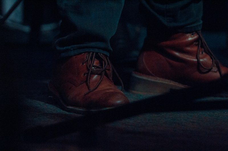 man wearing brown chelsea boots