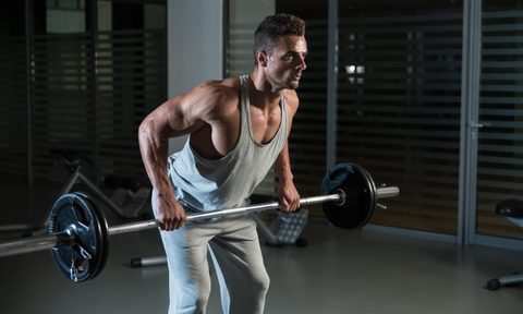 Man wearing gray vest doing bent-over barbell row