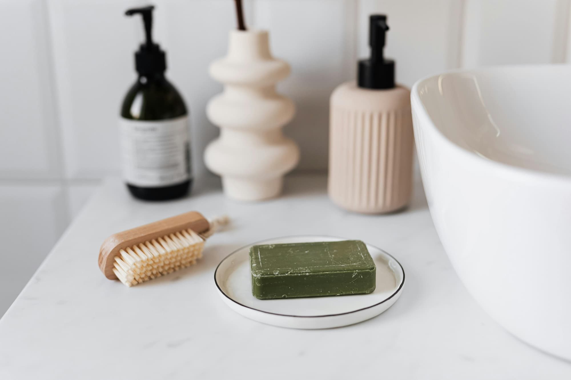 green bar of soap on a ceramic plate