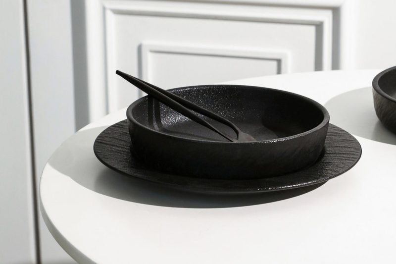 Stone + Lain Senso Bone China dinnerware set in black on a stark white table.